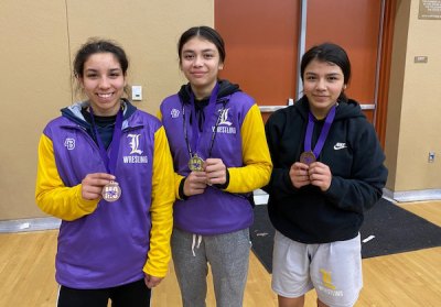 Left to right: Desiree Peralta, Marisa Perico, and Mariah Perico show off medals.